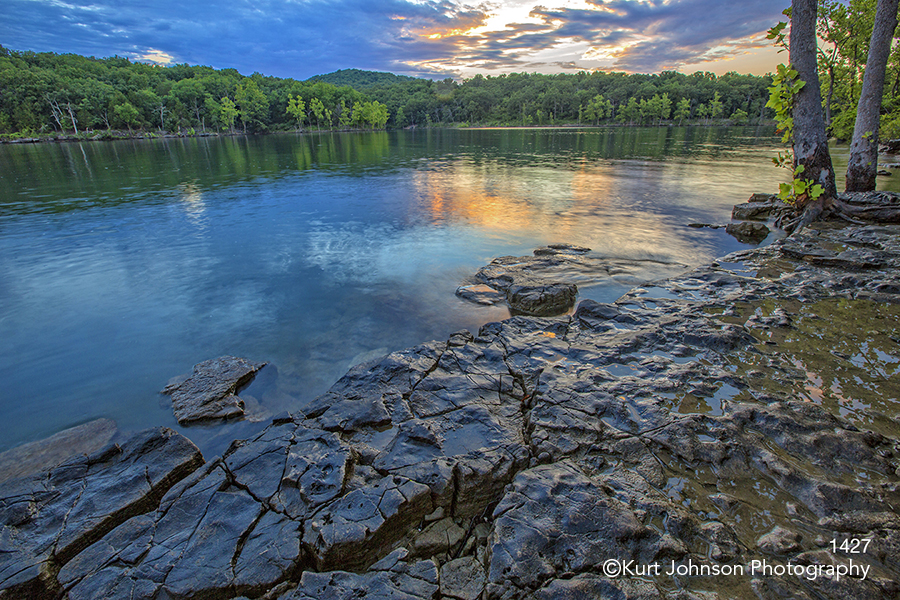 water rocks sunset trees lake