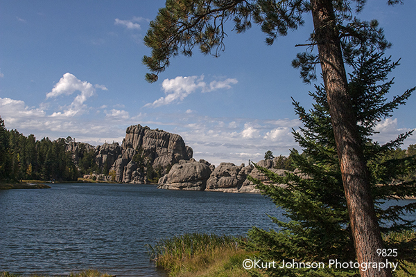 water waterscape waterscapes mountains rock blue sky clouds green