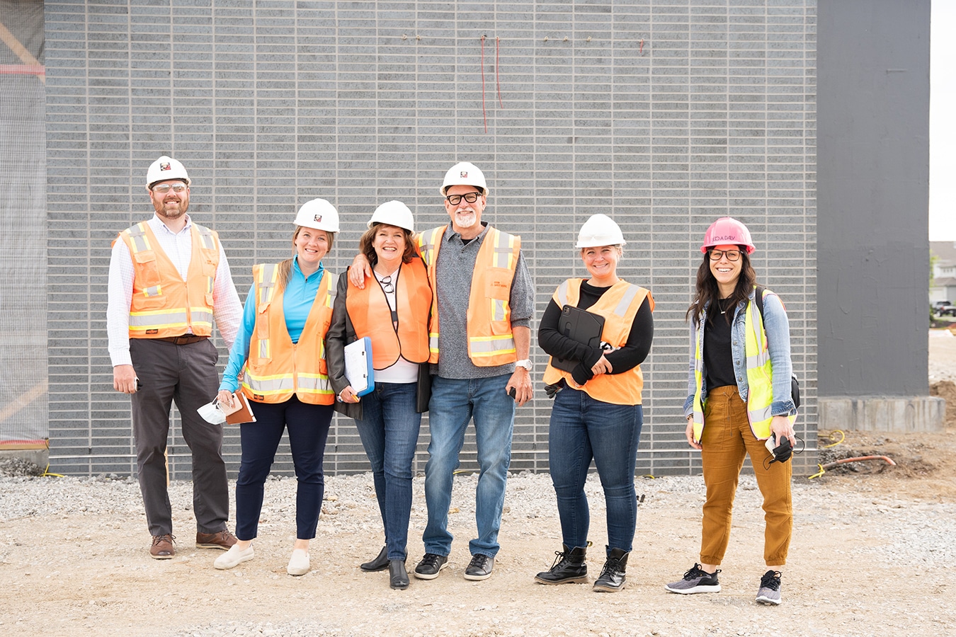 Kurt and Carolyn Johnson healthcare fine art nature photography company wearing hardhats on the job site of a new healthcare project with Leo A Daly designer Sabrina Ahern and Katie Benak of Ortho Nebraska in Omaha.