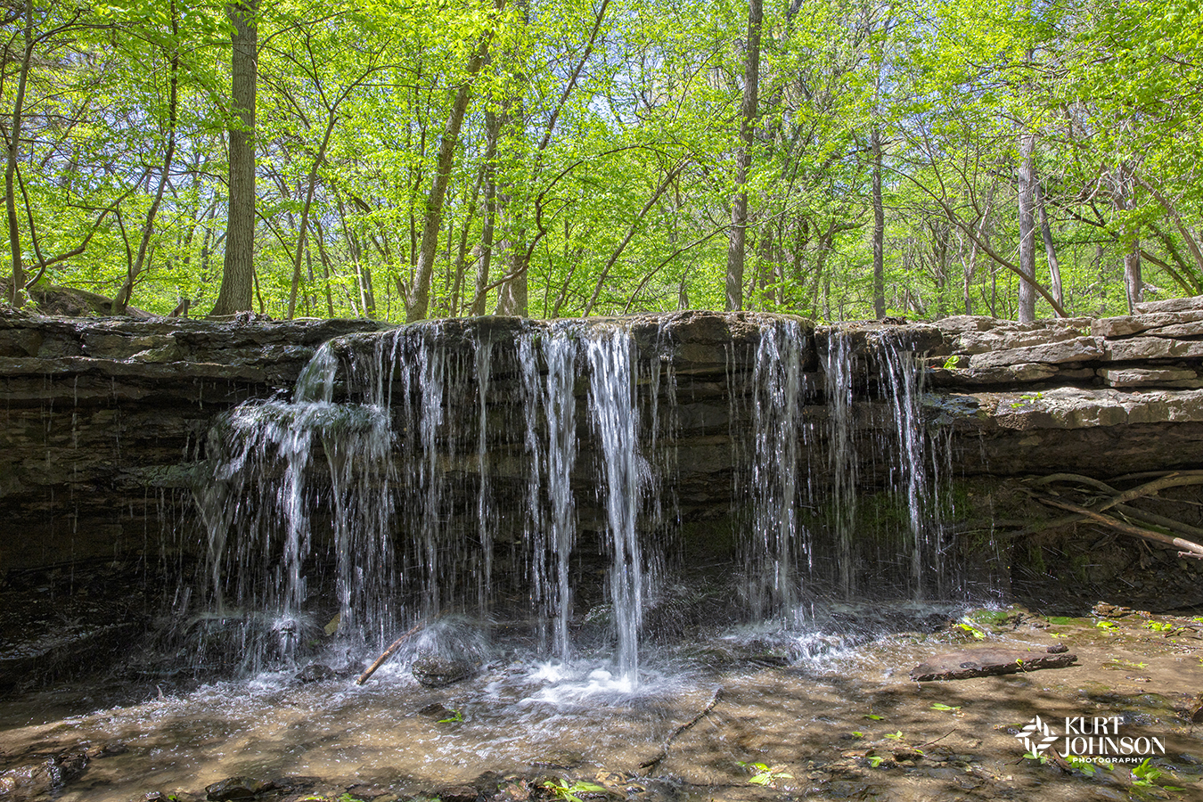 A soothing waterfall with lush green trees in the background is the perfect scene for healthcare environments to create positive distractions for patients. 